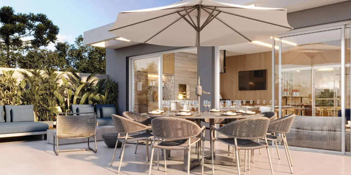 Espaço Gourmet externo com mesa longa e cadeiras