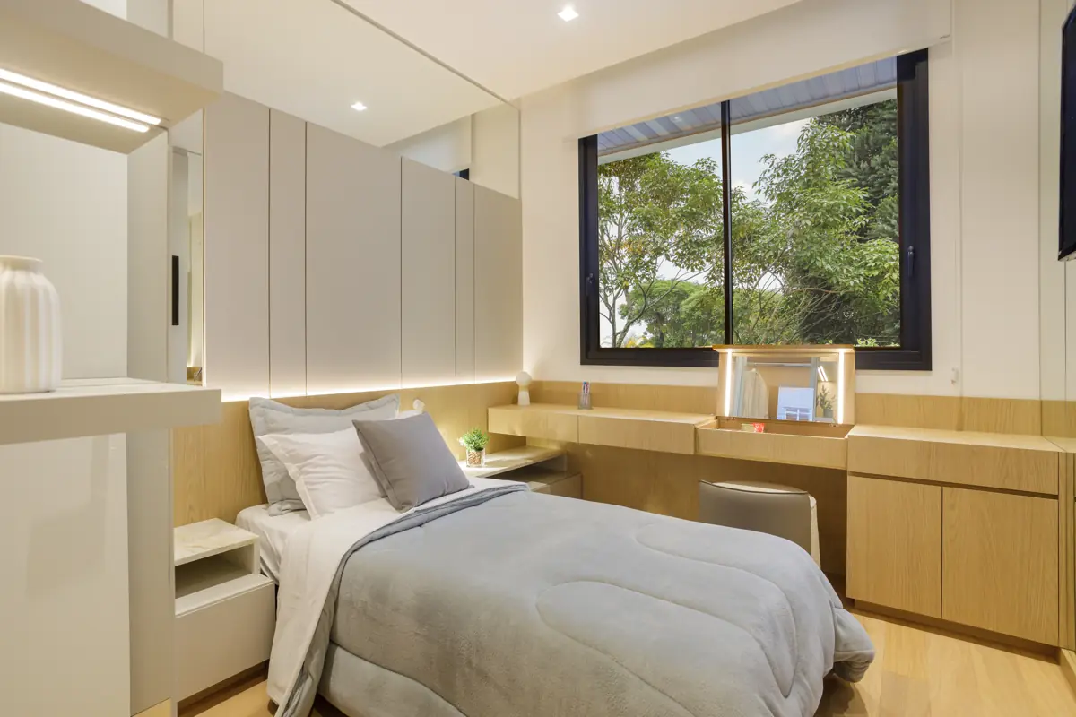 Apartamento decorado do Réve: quarto com painel de madeira, bancada de apoio e janela para área verde