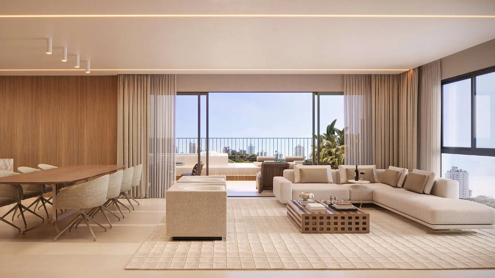 Sala ampla com mesa de jantar e sofá, aberta para o terraço
